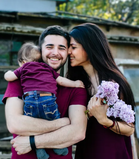 Parents holding their young child